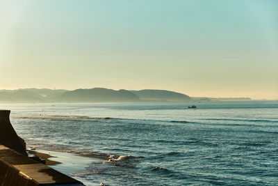 Scenic view of sea against clear sky during sunset