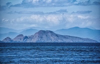 Scenic view of mountains against blue sky