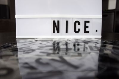 Close-up of text on glass table