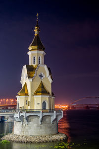 Illuminated building against sky at night