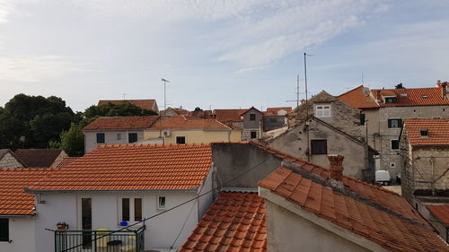 Houses in town against sky