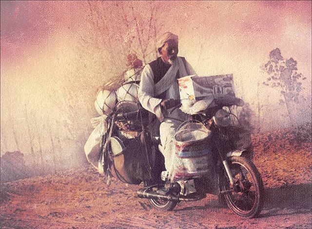 MAN RIDING HORSE CART ON MOTORCYCLE