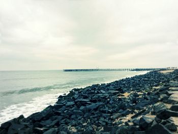 Scenic view of calm sea against cloudy sky