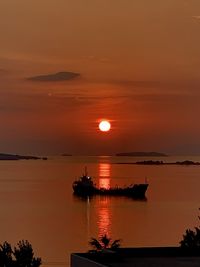 Scenic view of sea against orange sky