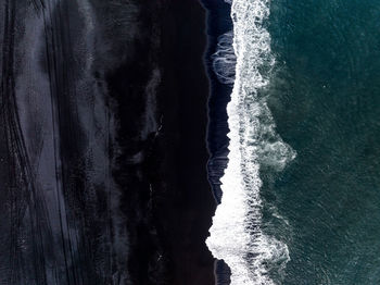 Iceland black sand beach with huge waves at reynisfjara vik.