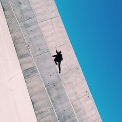 Tilt image of man on retaining wall