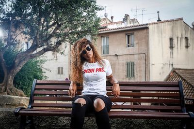 Woman sitting on bench in park