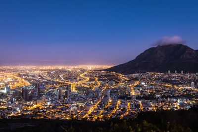 High angle view of illuminated buildings in city at night