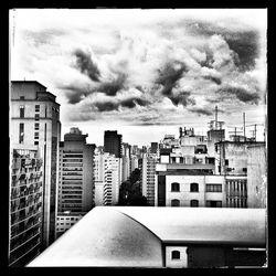 Buildings against cloudy sky