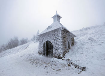 House on snow covered field