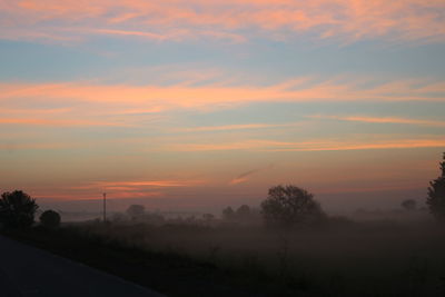 Scenic view of landscape against sky at sunset