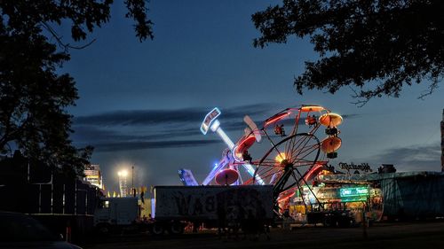 Illuminated ferris wheel at night