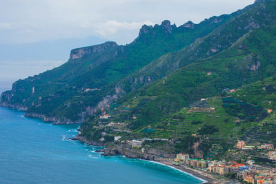 Scenic view of sea and mountains against sky