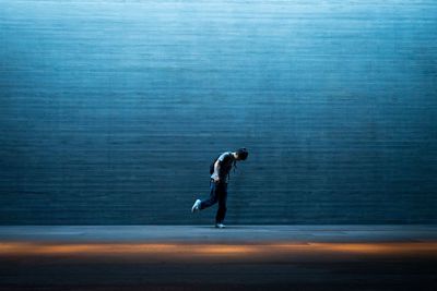 Side view of man running on road