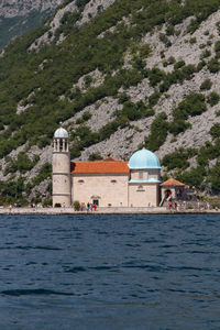 Building by sea against mountain