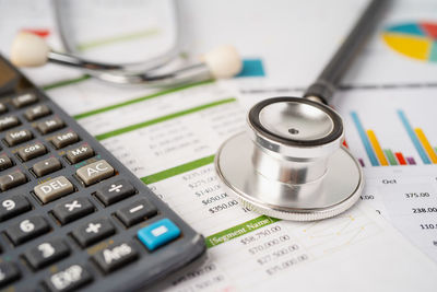 Close-up of stethoscope with calculator