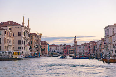 View of buildings in city at sunset