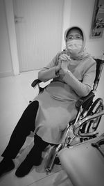 Portrait of woman sitting at home