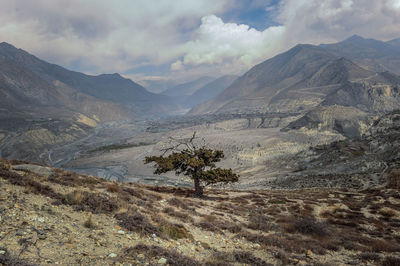 Scenic view of mountains against cloudy sky
