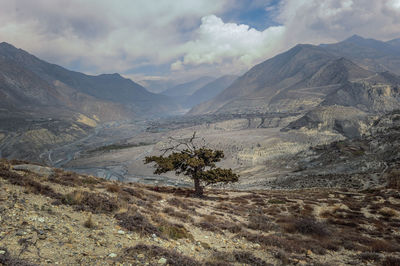 Scenic view of valley and mountains against sky