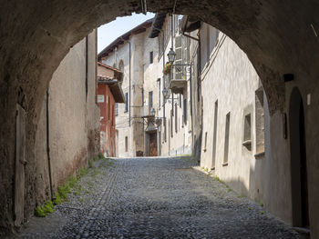 Empty alley amidst buildings in city