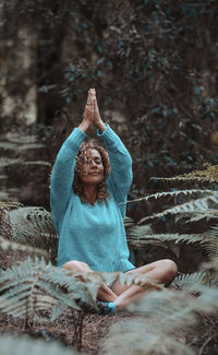 Portrait of woman sitting on rock