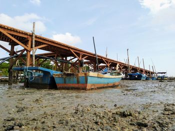 View of ship moored at beach against sky