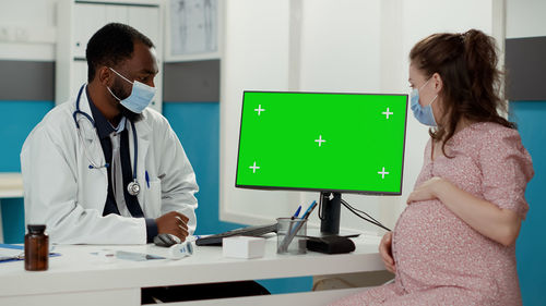 Female doctor examining patient in clinic