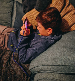 Boy holding phone at home
