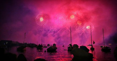 Firework display against sky at night