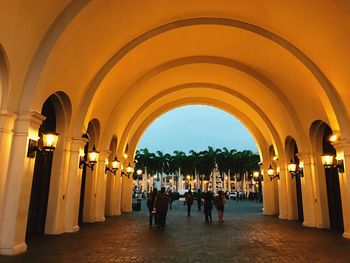 People walking in illuminated building