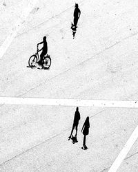 High angle view of people riding bicycle on street