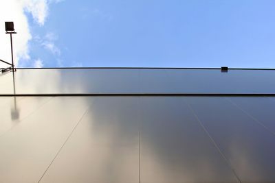 Low angle view of power lines against blue sky