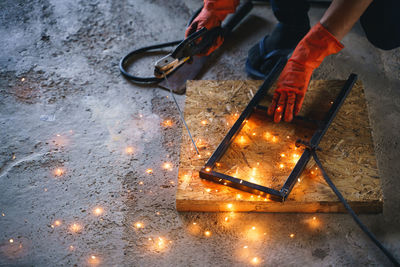 Low section of person working on metal