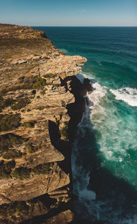 Scenic view of rocks in sea against sky