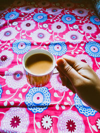 Midsection of woman holding coffee cup