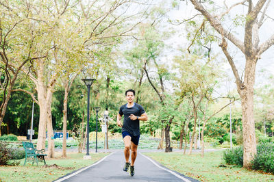 Full length of man running on road