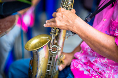 Midsection of man playing trumpet