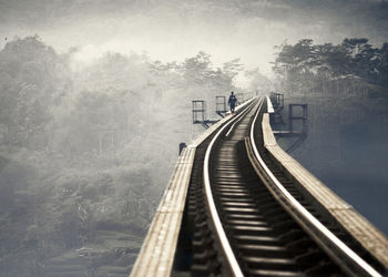 Man walking on railway bridge