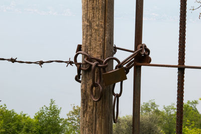 Close-up of padlock on chain against sky