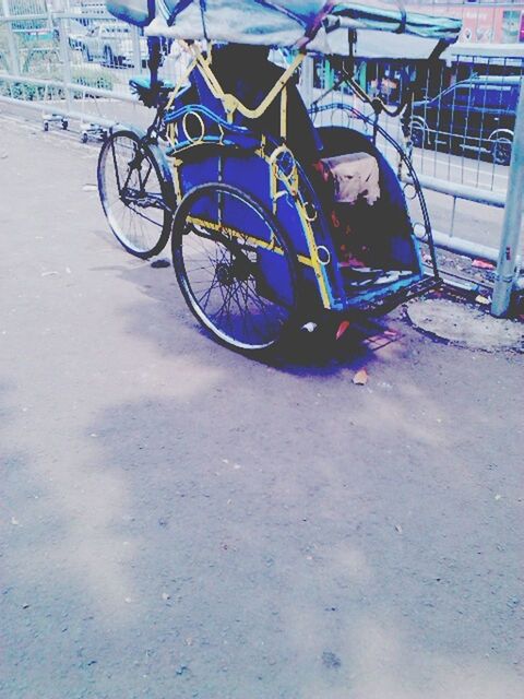 transportation, mode of transport, land vehicle, bicycle, stationary, parking, street, parked, wheel, car, travel, day, outdoors, sunlight, motorcycle, road, high angle view, shadow, tire, incidental people