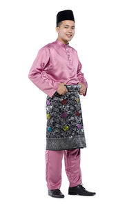 Full length of a smiling girl standing against white background