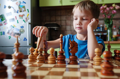 Close-up of boy playing chess