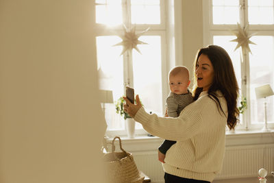 Mother taking selfie with baby