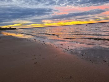 Scenic view of beach against sky during sunset