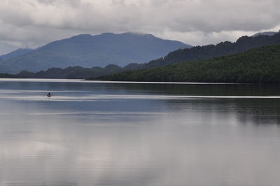 Scenic view of mountains against cloudy sky