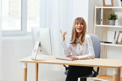 Young woman using laptop at home