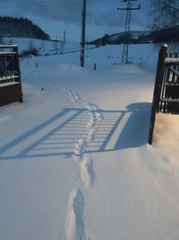 Snow covered landscape against sky