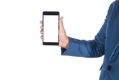 Midsection of man showing smart phone against white background