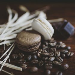 High angle view of roasted coffee bean along with biscuits